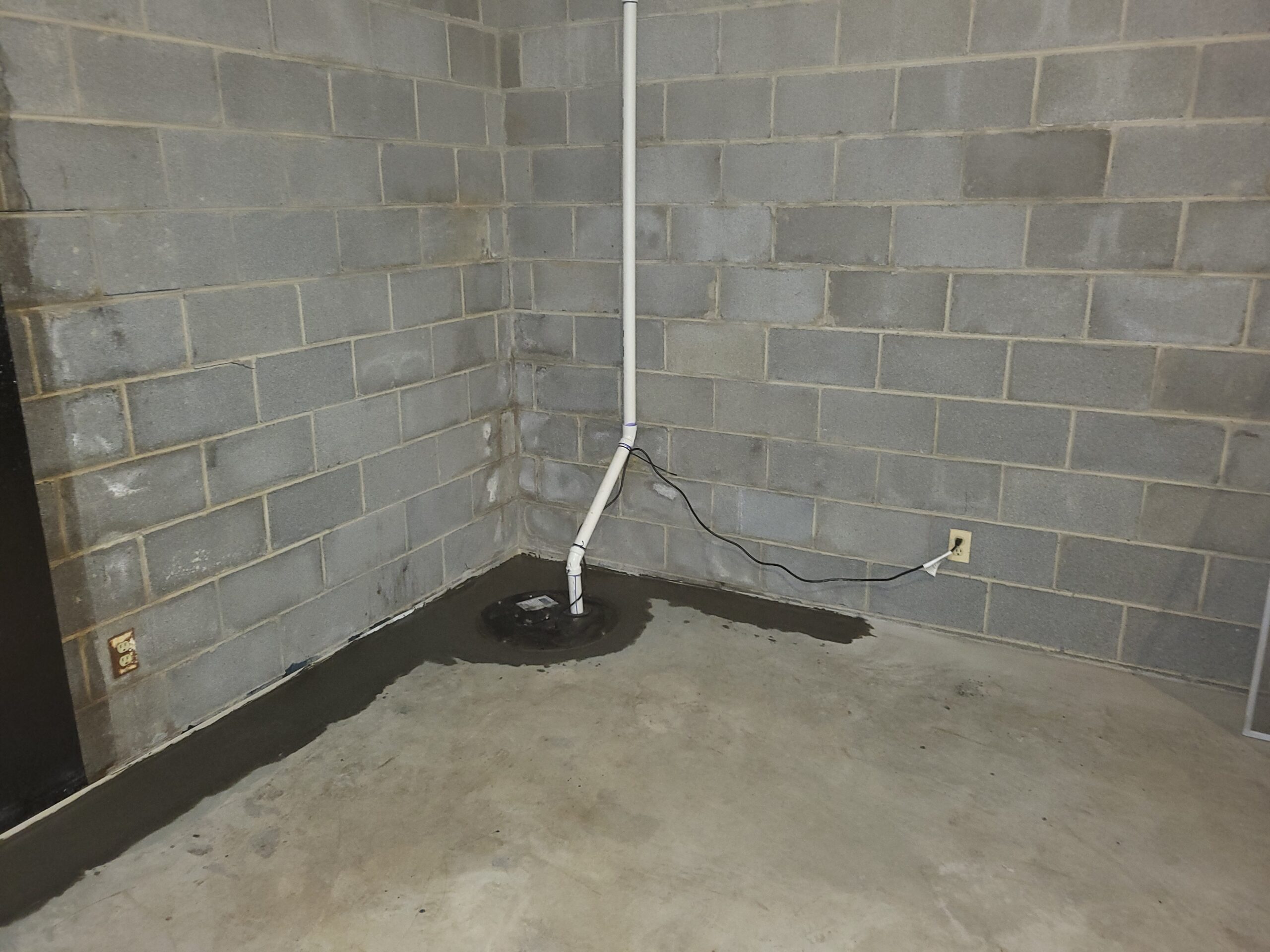 A sump pump and drain as part of an interior waterproofing and drainage system